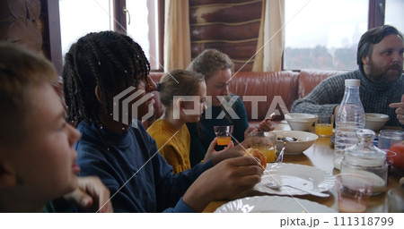 Yong girl with mom dip pancakes in condensed milk Yong girl with mom dip pancakes in condensed milk 111318799