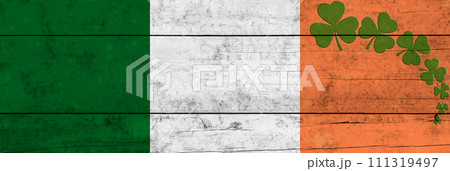 St. Patrick's Day background. Shamrocks against the background of the Irish flag. Decoration for St. Patrick's Day. St. Patrick's Day background. Shamrocks against the background of the Irish flag. Decoration for St. Patrick's Day. 111319497
