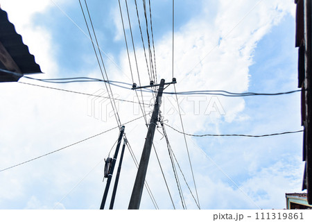 high power pole with lots of wires and pretty white sky background 111319861