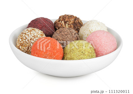 A variety of different truffles in a ceramic bowl Isolated on a white background A variety of different truffles in a ceramic bowl Isolated on a white background 111320011