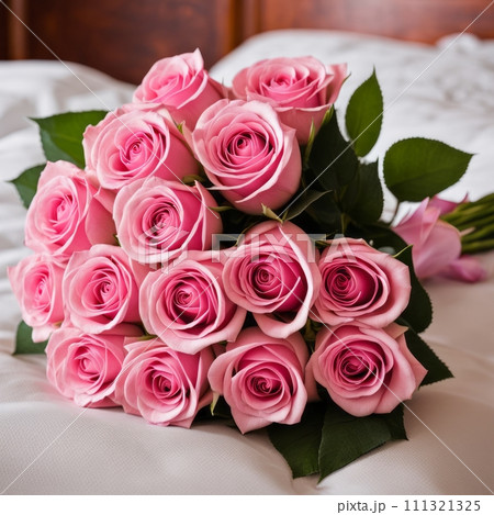 Bouquet of Pink roses on the bed in a hotel room for honeymoon. romantic meeting of guests at the hotel 111321325