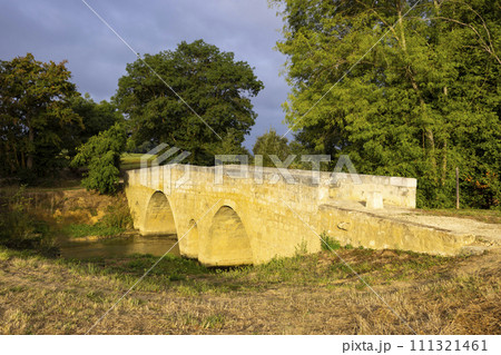 Romanesque bridge of Artigue and river Osse near Larressingle on route to Santiago de Compostela, UNESCO World Heritage Site, departement Gers, France 111321461