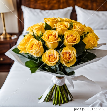 Bouquet of Yellow roses on the bed in a hotel room for honeymoon. romantic meeting of guests at the hotel. 111321717