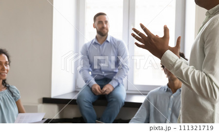 Business project leader, corporate teacher talking to employees in office 111321719