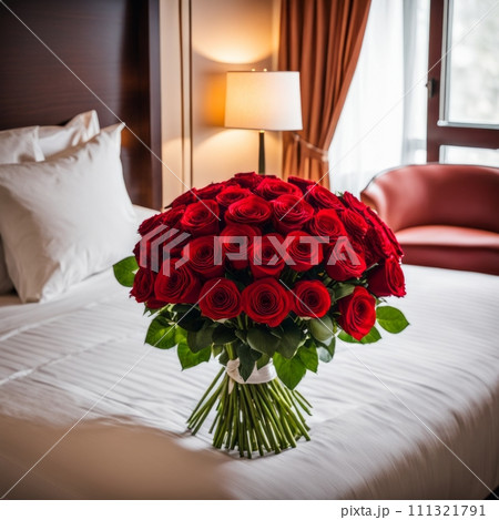 Bouquet of red roses on the bed in a hotel room for honeymoon. romantic meeting of guests at the hotel 111321791