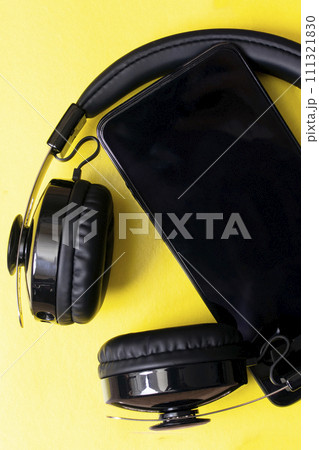 Headphones and phone on a yellow background Headphones and phone on a yellow background 111321830