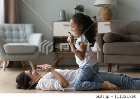 Little Indian girl play patty cake with young mother Little Indian girl play patty cake with young mother 111321860