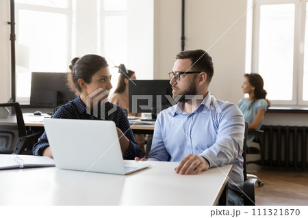 Diverse business colleagues cooperating on project tasks at laptop 111321870