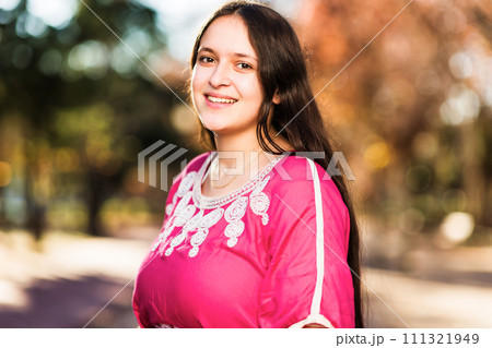 Middle eastern Moroccan happy young woman portrait outdoors. With traditional Arab dress Middle eastern Moroccan happy young woman portrait outdoors. With traditional Arab dress 111321949