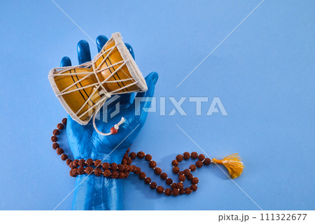 Shivaratri background with Shiva hand and Drum Damroo musical instrument. Maha Shivratri festval. Shivaratri background with Shiva hand and Drum Damroo musical instrument. Maha Shivratri festval. 111322677