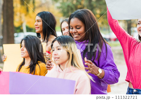 Group of protest strike rally march from female rights activist holding empty placard outdoors. 111322721