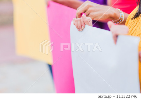 Group of protest strike rally march from female rights activist holding empty placard outdoors. 111322746