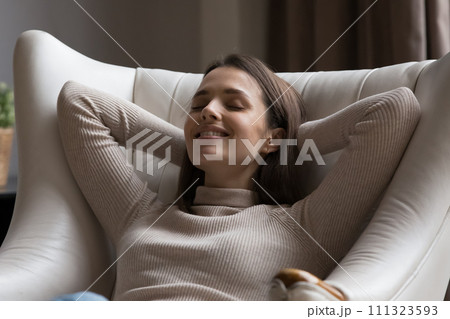 Close up shot beautiful woman relax leaned on leather armchair Close up shot beautiful woman relax leaned on leather armchair 111323593
