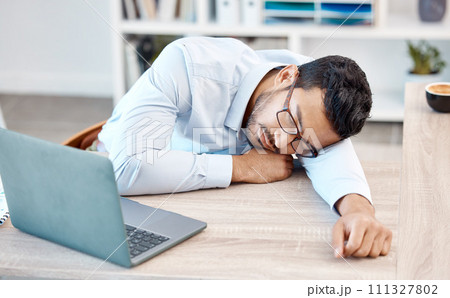 Tired, headache and sleeping worker behind laptop while lying his head on his desk in his office. Stress, burnout and chronic fatigue with young professional male feeling exhausted and overworked Tired, headache and sleeping worker behind laptop while lying his head on his desk in his office. Stress, burnout and chronic fatigue with young professional male feeling exhausted and overworked 111327802