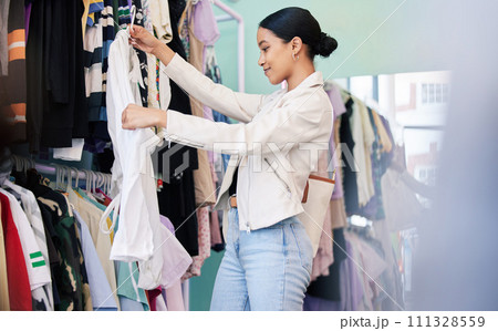 Happy, shopping and woman search with smile in shop, retail and mall for fashion clothes in store. Designer, customer and small business girl spending money on brand clothing or black Friday sale Happy, shopping and woman search with smile in shop, retail and mall for fashion clothes in store. Designer, customer and small business girl spending money on brand clothing or black Friday sale 111328559
