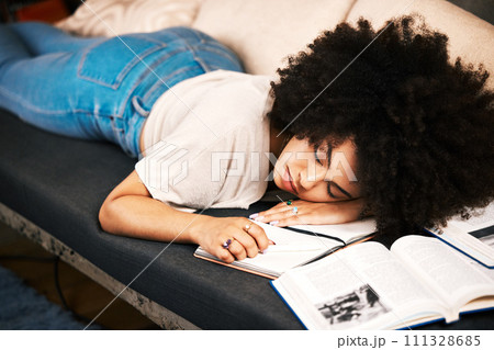 Education, learning and sleeping with a tired, exhausted and overworked woman student studying on a sofa in her home. Burnout and exhaustion with a female learner in her house to study and learn Education, learning and sleeping with a tired, exhausted and overworked woman student studying on a sofa in her home. Burnout and exhaustion with a female learner in her house to study and learn 111328685