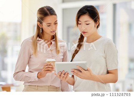 Business team with digital tablet support, collaboration and teamwork while planning a strategy in an advertising office. Corporate women share idea while searching social media on app together Business team with digital tablet support, collaboration and teamwork while planning a strategy in an advertising office. Corporate women share idea while searching social media on app together 111328703
