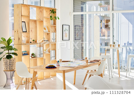 Empty interior office with light, wood furniture and workplace space for business and work. Modern and minimalist design decoration of a corporate or creative room for working employee or staff 111328704