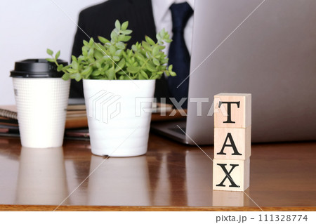 税金TAXイメージと男性とノートパソコン Tax, man and laptop 税金TAXイメージと男性とノートパソコン Tax, man and laptop 111328774