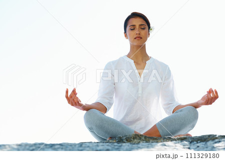 Woman, meditation and yoga in zen for spiritual wellness, awareness or outdoor beach with sky background. Calm female person or yogi meditating for inner peace, breathing or health on mockup space 111329180