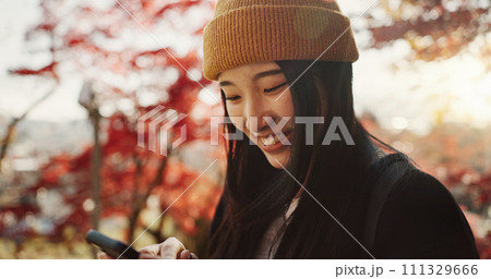 Selfie, travel and Japanese woman in forest for holiday, vacation and adventure in Japan. Happy, smile and person take picture on smartphone in nature for social media post, memories and online blog 111329666