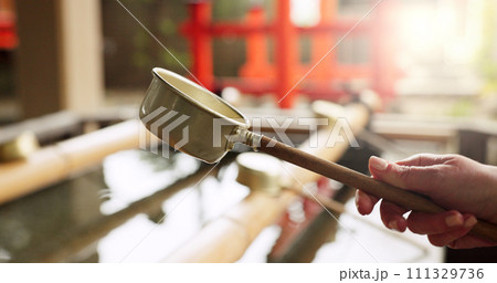 Shinto shrine, hands and fountain with water in container for faith, clean or washing for wellness. Religion, culture and praise with ladle for purification ritual in woods, peace or temple in Kyoto 111329736