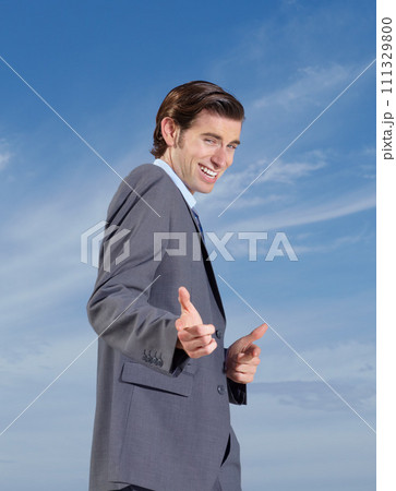 Business, portrait and man with hand pointing at you for support outdoor on blue sky background. We are hiring, recruitment or recruiter face smile with travel agency promotion or finger emoji choice 111329800