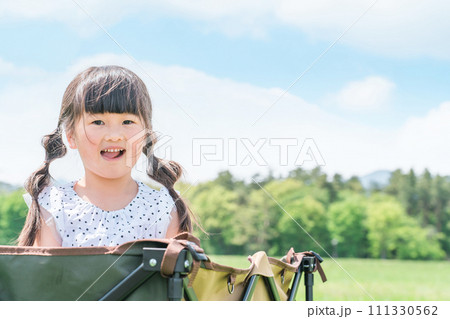 アウトドア・公園でキャリーワゴンに乗って遊ぶ子供（女の子・キャンプ） 111330562
