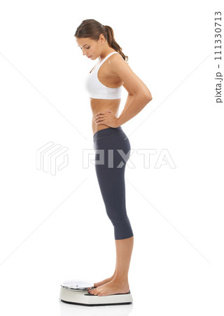 Woman, scale and for lose weight diet in studio for healthy body, performance or self care. Female person, equipment and target or mockup on white background for fitness training, routine or goals 111330713