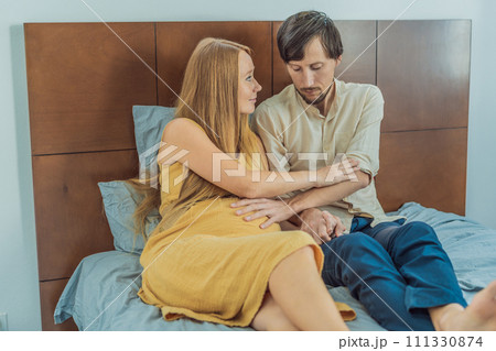 Concerned husband anxiously worries about his wife's pregnancy, seeking reassurance and support 111330874