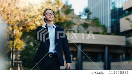 Phone call, walking and business man on city journey, morning travel and speaking on mobile discussion. Smartphone conversation, communication and Japanese agent talking with contact on urban commute Phone call, walking and business man on city journey, morning travel and speaking on mobile discussion. Smartphone conversation, communication and Japanese agent talking with contact on urban commute 111330881