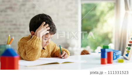 Child, drawing or boy writing homework on notebook in kindergarten education for growth development. Project, creative or young art student with color pencil learning or working on sketching skills 111331523