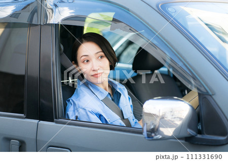 車を運転する女性配達員 111331690