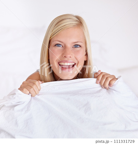 Happy, portrait and woman in a bed with blanket, joy or waking up in a playful mood at home. Morning energy, face or excited female person in bedroom with smile, game or funny personality in house 111331729
