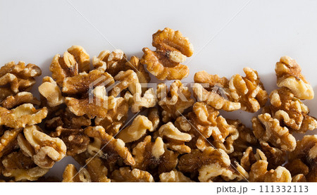 Dry peeled walnut in glass bowl on white background, nobody Dry peeled walnut in glass bowl on white background, nobody 111332113