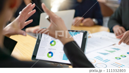 People, meeting and tablet screen of data analytics, graphs and statistics in finance, business or revenue proposal. Professional employees, analyst or manager talking of digital sales and documents 111332803
