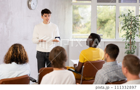 Young student presenting report to group of male students Young student presenting report to group of male students 111332897