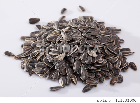 Sunflower seeds on a white surface Sunflower seeds on a white surface 111332986