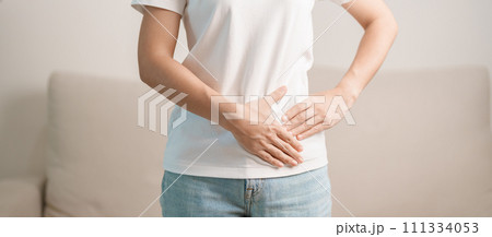 Woman having abdomen pain on the sofa at home. Liver cancer and Tumor, kidney cancer, Jaundice, Viral Hepatitis, Cirrhosis, Failure, Enlarged, Hepatic Encephalopathy, Stomach and health concept Woman having abdomen pain on the sofa at home. Liver cancer and Tumor, kidney cancer, Jaundice, Viral Hepatitis, Cirrhosis, Failure, Enlarged, Hepatic Encephalopathy, Stomach and health concept 111334053