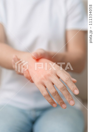 Woman having wrist pain during sitting on sofa at home, muscle ache due to De Quervain s tenosynovitis, ergonomic, Carpal Tunnel Syndrome or Office syndrome concept Woman having wrist pain during sitting on sofa at home, muscle ache due to De Quervain s tenosynovitis, ergonomic, Carpal Tunnel Syndrome or Office syndrome concept 111334058