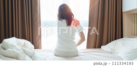 Woman having Shoulder and Neck pain during sitting on bed at home. Muscle painful due to Myofascial pain syndrome and Fibromyalgia, rheumatism, Scapular pain, Cervical Spine. Waking and Health concept Woman having Shoulder and Neck pain during sitting on bed at home. Muscle painful due to Myofascial pain syndrome and Fibromyalgia, rheumatism, Scapular pain, Cervical Spine. Waking and Health concept 111334193