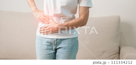 Woman having abdomen pain on the sofa at home. Liver cancer and Tumor, kidney cancer, Jaundice, Viral Hepatitis, Cirrhosis, Failure, Enlarged, Hepatic Encephalopathy, Stomach and health concept 111334212