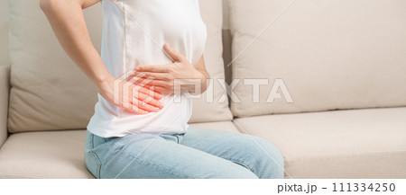 Woman having abdomen pain on the sofa at home. Liver cancer and Tumor, kidney cancer, Jaundice, Viral Hepatitis, Cirrhosis, Failure, Enlarged, Hepatic Encephalopathy, Stomach and health concept Woman having abdomen pain on the sofa at home. Liver cancer and Tumor, kidney cancer, Jaundice, Viral Hepatitis, Cirrhosis, Failure, Enlarged, Hepatic Encephalopathy, Stomach and health concept 111334250