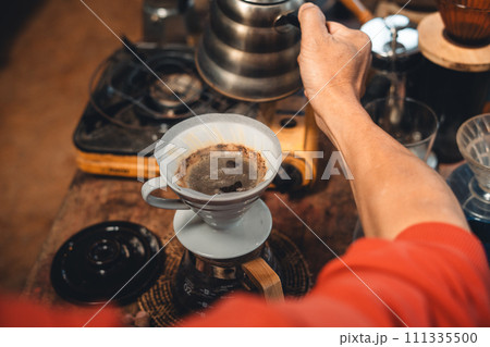 Drip coffee,coffee dripper and hands barista make coffee Drip coffee,coffee dripper and hands barista make coffee 111335500
