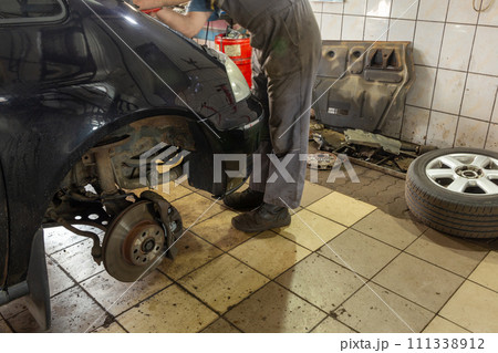 Car mechanic working in auto repair shop. Car mechanic working in auto repair shop. 111338912