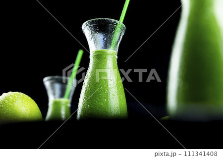 Healthy green smoothies with spinach, apple, kiwi, broccoli and mint in glass jar with fruits and vegetables on the wooden table. Detox and healthy concept 111341408