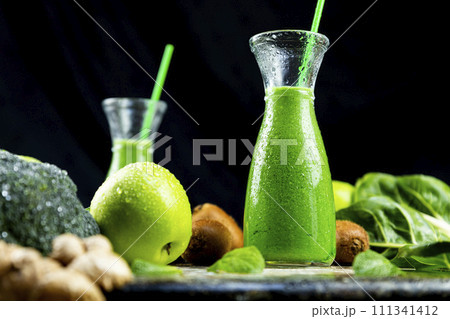 Healthy green smoothies with spinach, apple, kiwi, broccoli and mint in glass jar with fruits and vegetables on the wooden table. Detox and healthy concept 111341412