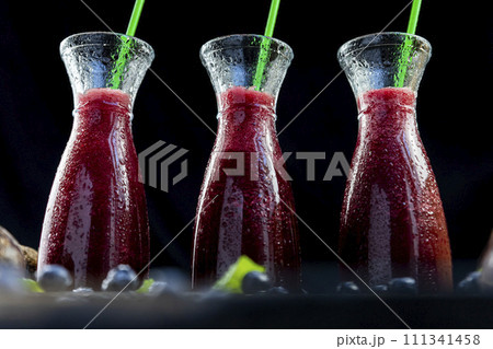 Smoothies with Beetroot, blueberries and mint in glass jar with fruits and vegetables on the wooden table. Detox, diet, healthy, vegetarian drink concept 111341458