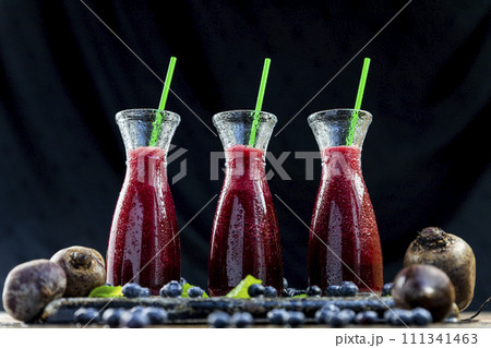 Smoothies with Beetroot, blueberries and mint in glass jar with fruits and vegetables on the wooden table. Detox, diet, healthy, vegetarian drink concept 111341463