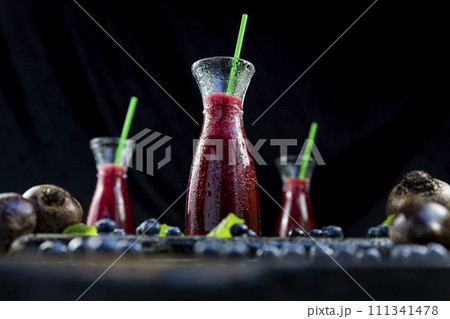 Juice with Beetroot, blueberries and mint in glass jar with fruits and vegetables on the wooden table. Detox, diet, healthy, vegetarian drink concept 111341478
